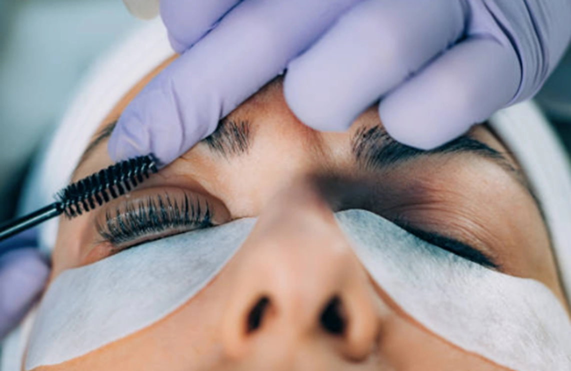 Applying lift and tint eyebrow treatment